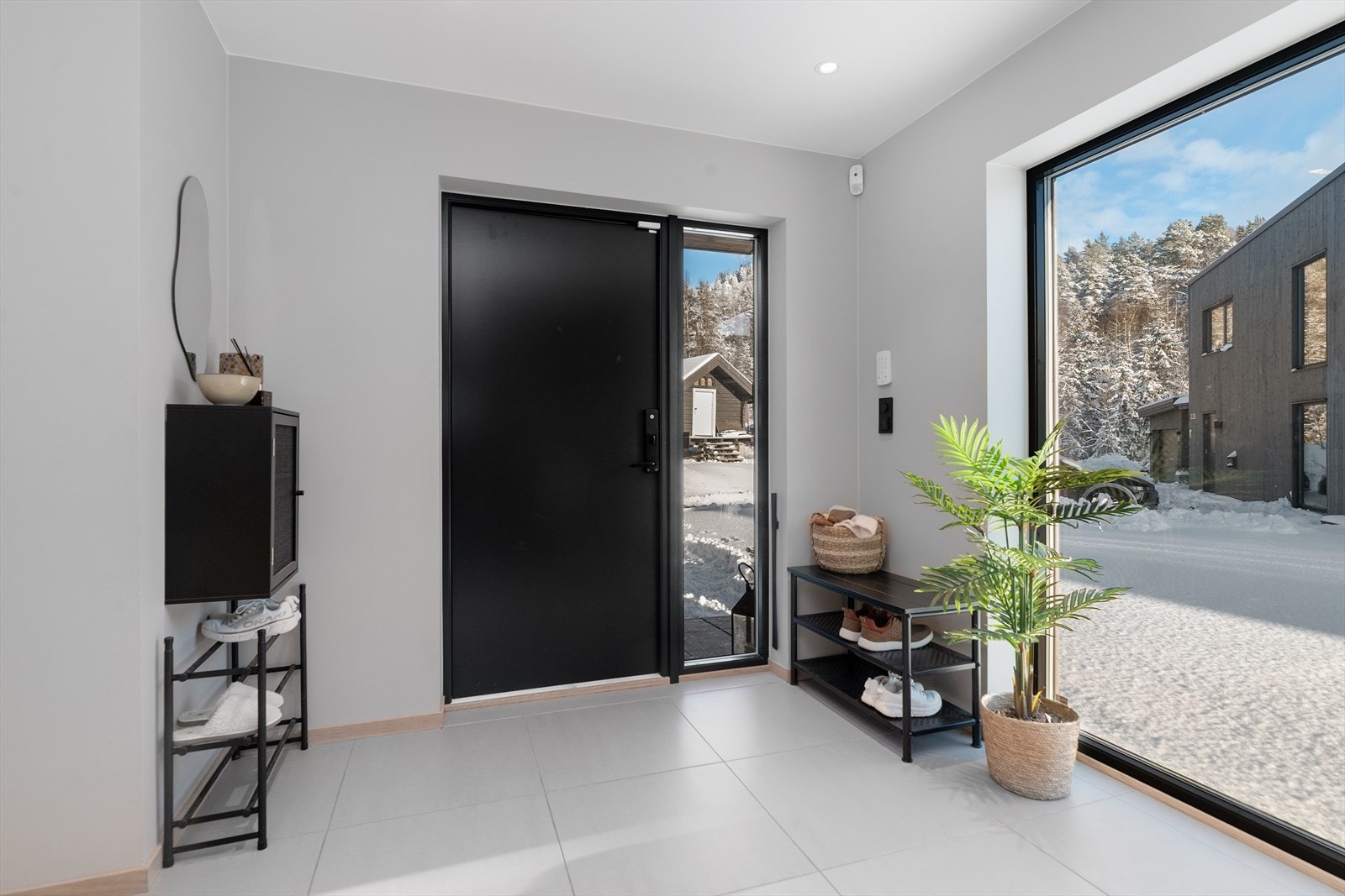 Når du åpner døren kommer du inn til en innbydende entré av god størrelse, med varmekabler og lyse, moderne overflater med stilige mørke detaljer. Her er det god plass til kommode og annet entrémøblement for oppbevaring av sko- og yttertøy. Galleribilde