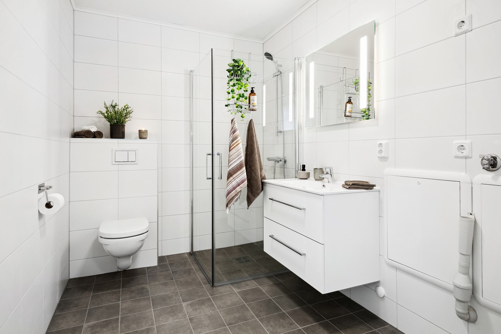 Flott flislagt bad med opplegg til vaskemaskin. Galleribilde