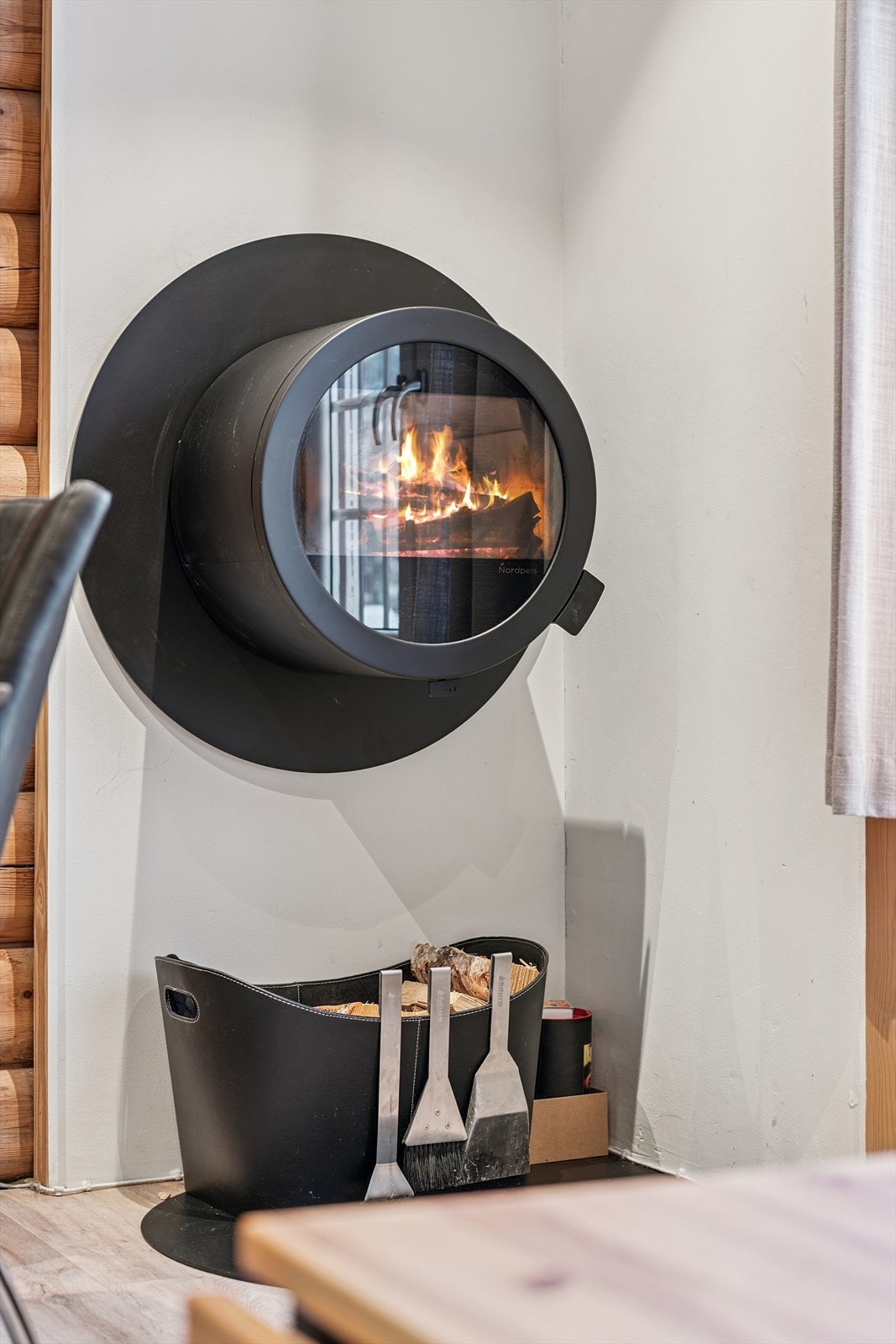 En moderne, veggmontert vedovn fra 2021 gir både hygge og god varme. Galleribilde