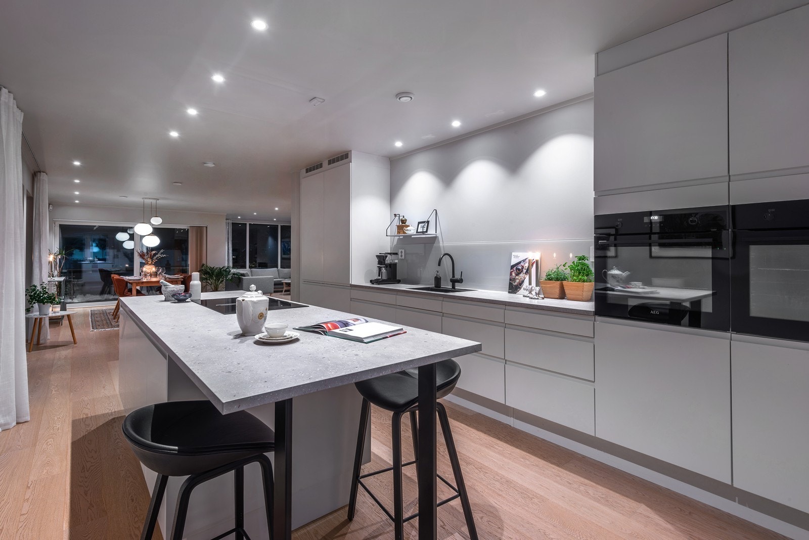 Den romslige kjøkkenøya fungerer både som ekstra arbeidsbenk og som en naturlig barløsning med sitteplasser. Galleribilde