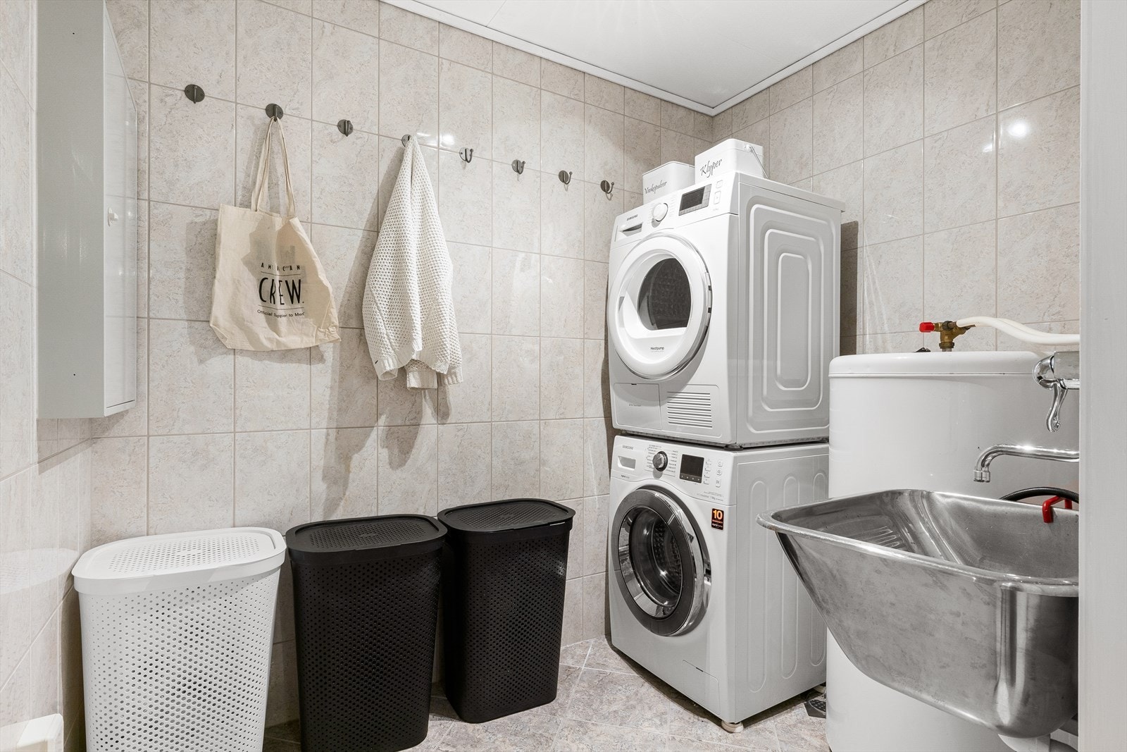 Stort og praktisk vaskerom med opplegg for vaskemaskin og tørketrommel Galleribilde