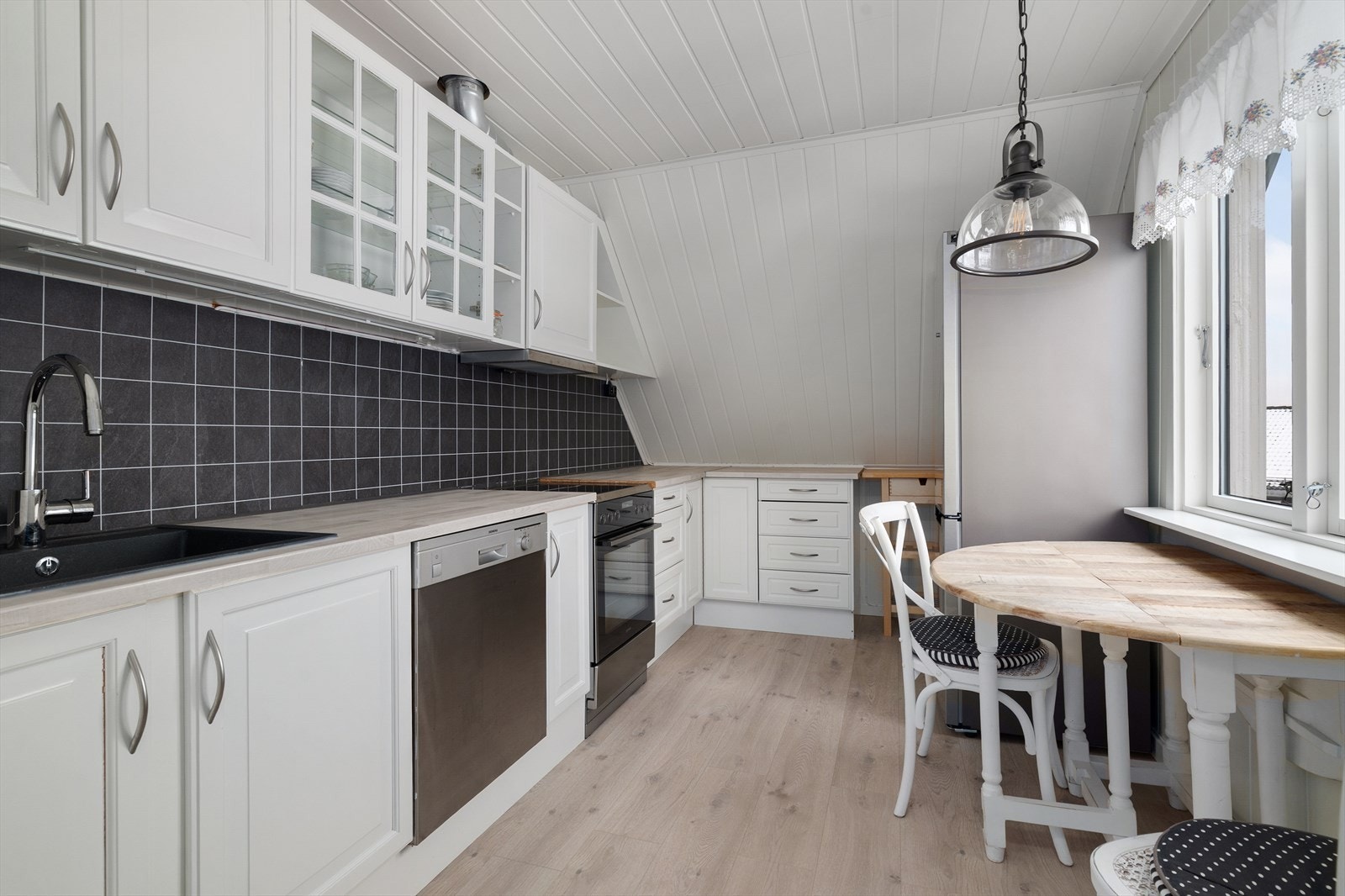 Koselig kjøkken med god skap- og benkeplass. Kjøkkenet har innredning med profilerte fronter og benkeplate av laminat. Over stekesone er det ventilator med avtrekk ut. Galleribilde