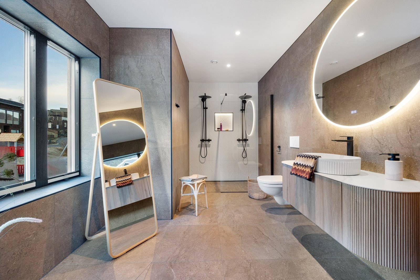 Badet tilknyttet hovedsoverommet i delikate toner og dobbel dusj. Galleribilde