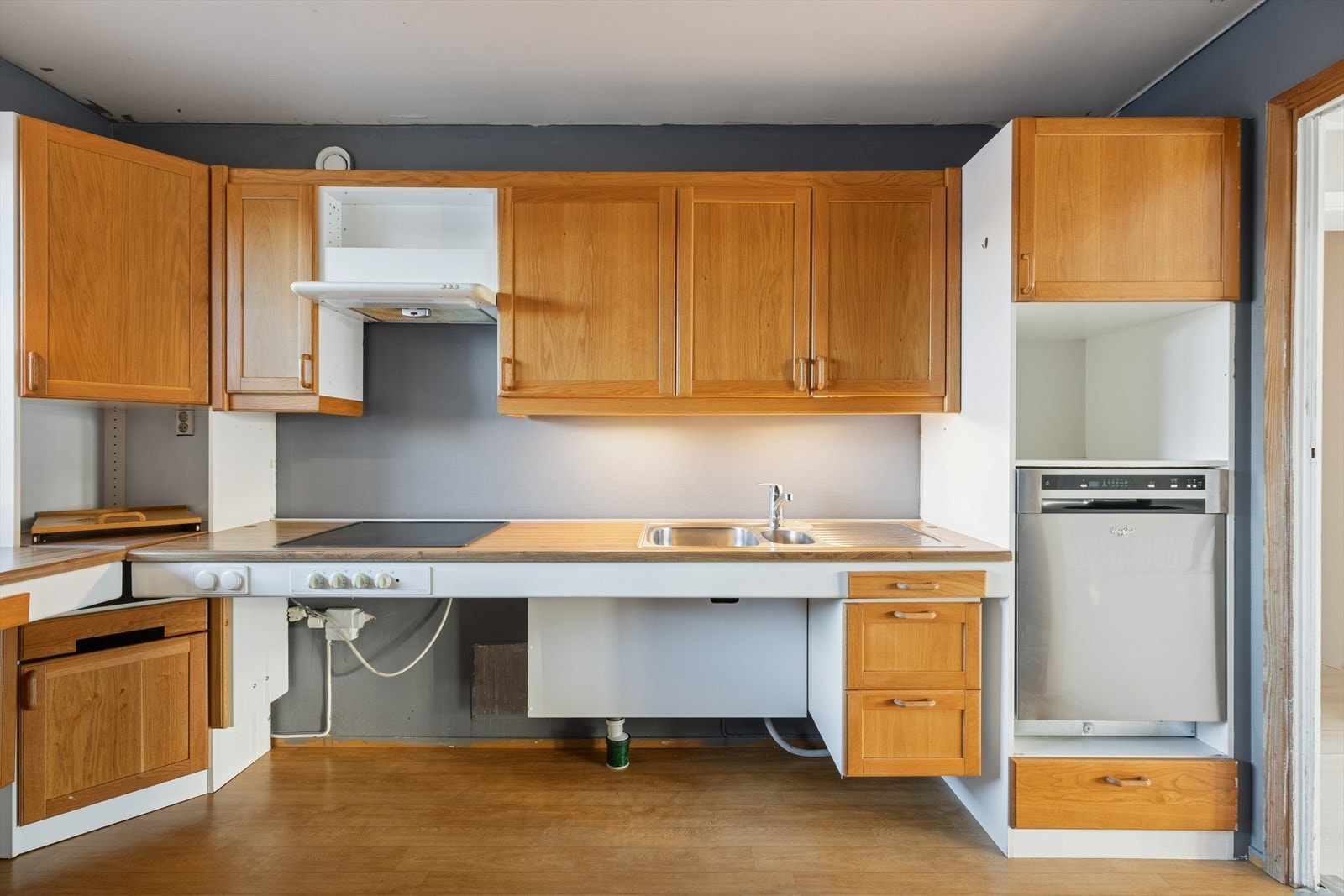 Det er malte flater over benken, utslagsvask med blandebatteri, samt belysning under overskapene Galleribilde