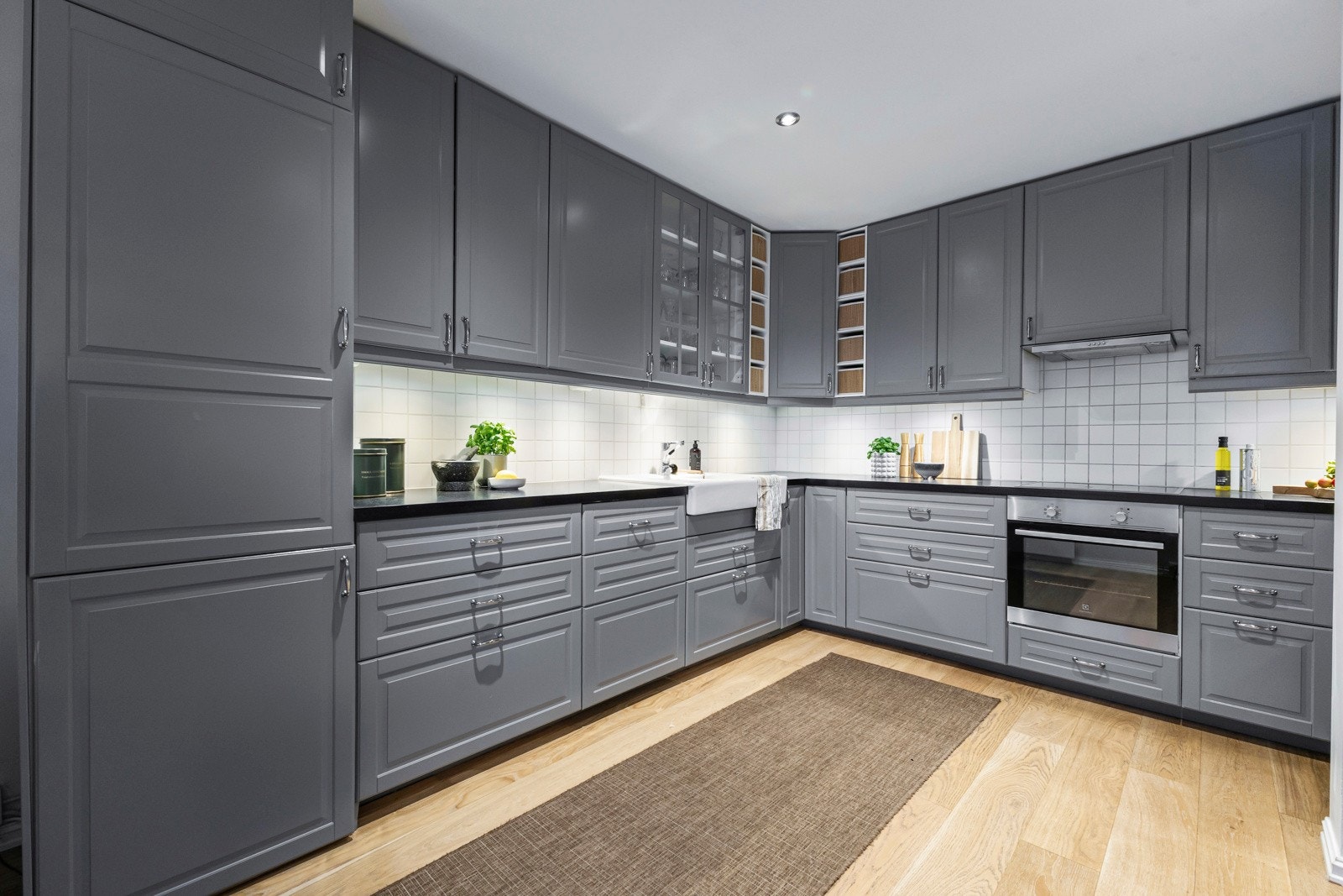 Laminert benkeplate, fliser over benk og gjennomtenkte arbeidsflater gir et funksjonelt og ryddig uttrykk. Galleribilde