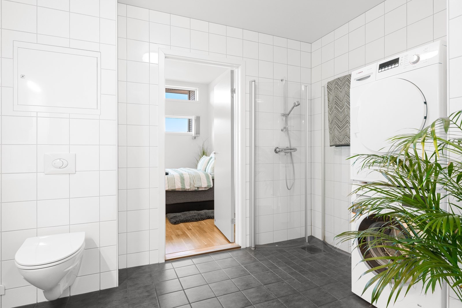 Bad/vaskerom er helfliset og har varme i gulv. Vegghengt wc og dusjhjørne. Galleribilde