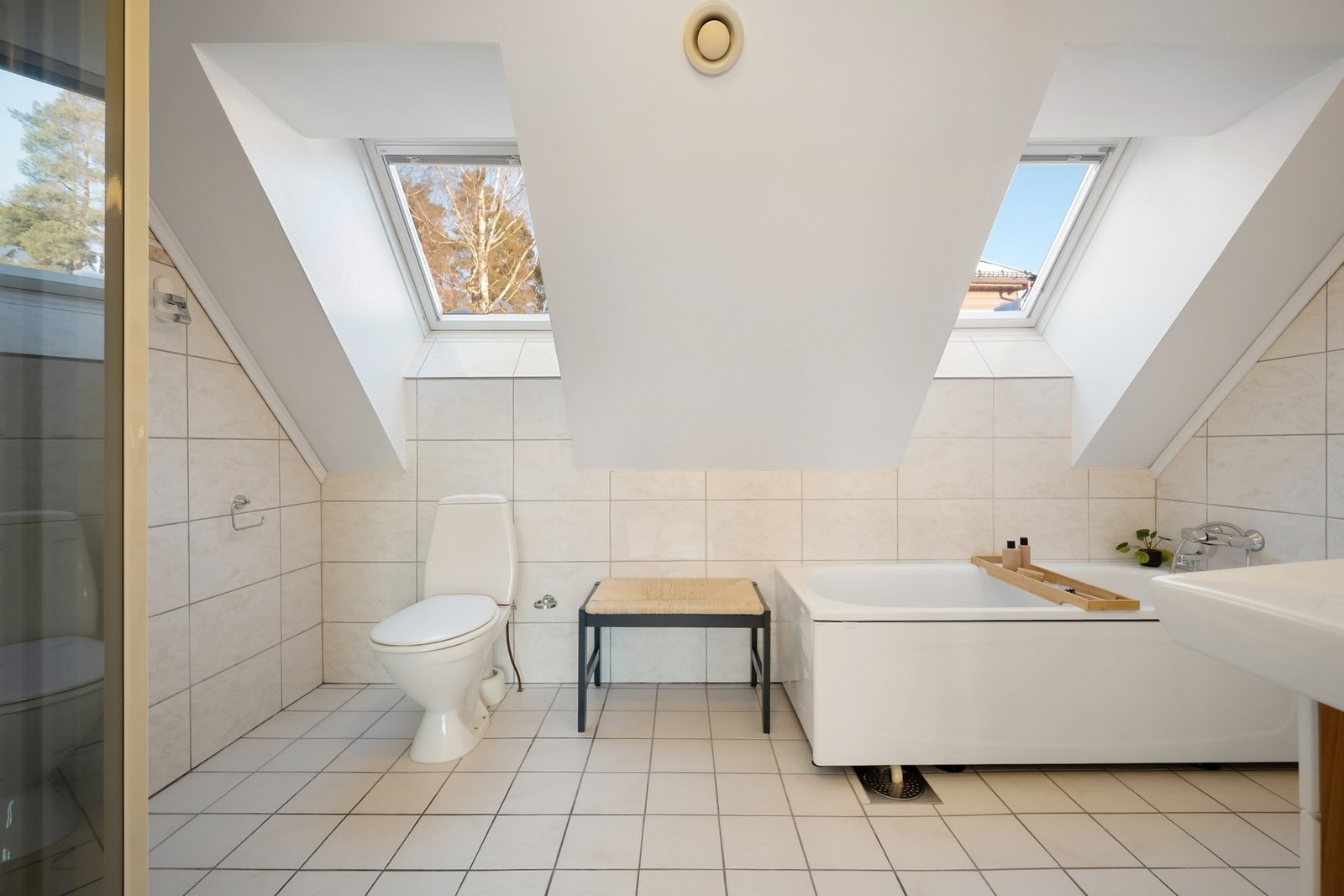 I 2.etg. er det flislagt bad med dusjnisje med dusjdører, badekar, servant med ett greps blandebatteri og gulvstående toalett. Galleribilde