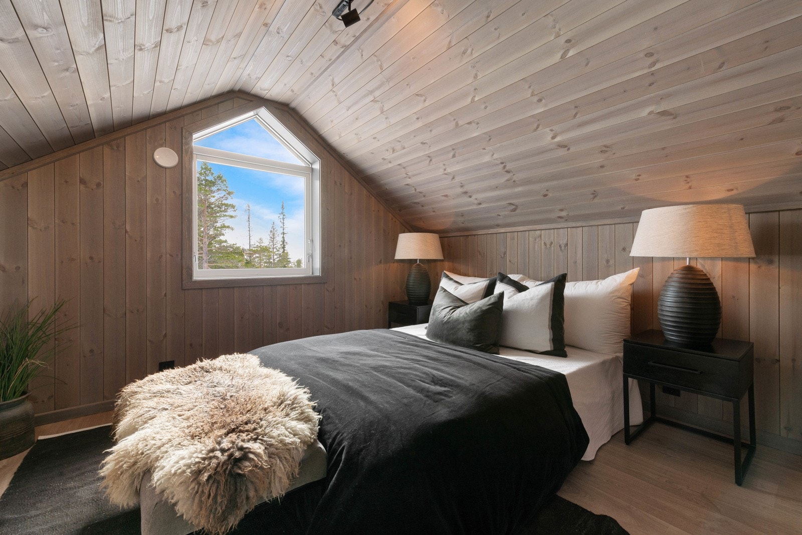 Fra soverommene oppe er det luker til lagringsplass i kneveggene, og det største soverommet nede har downlights i taket og utgang til hagen. Galleribilde