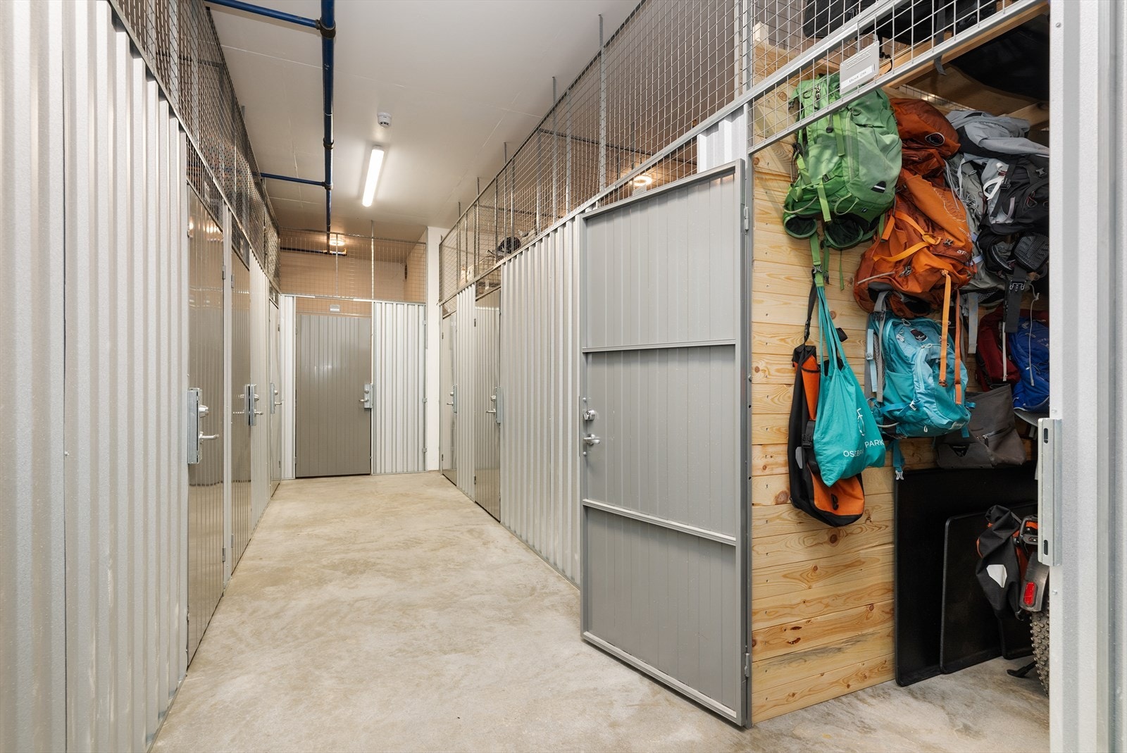 Praktisk bod i fellesareal Boden er innredet med hyller og knagger. Galleribilde