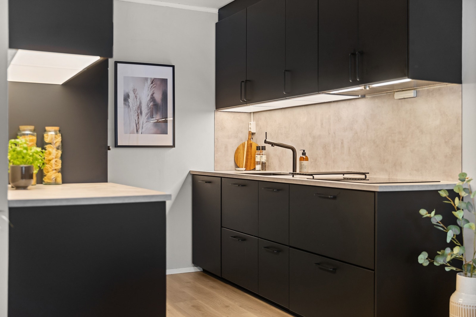 Innredningen har glatte, mørke fronter og en slitesterk laminatbenkeplate. Galleribilde