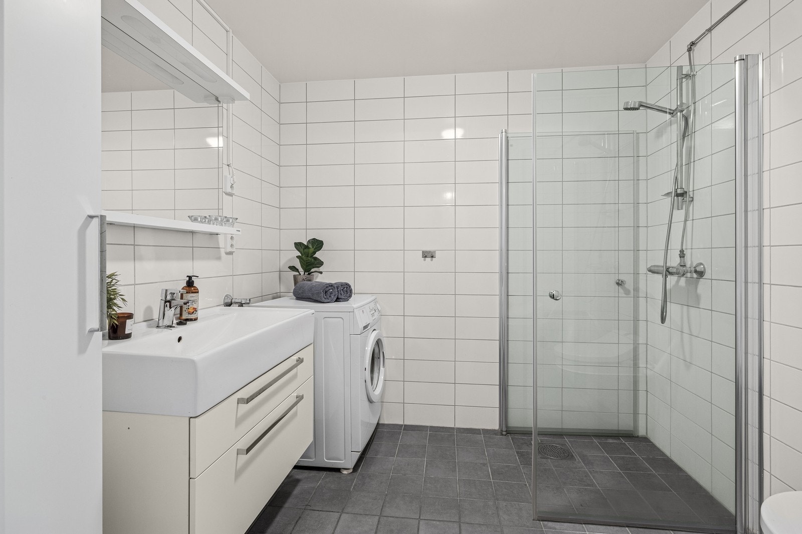 Bad med varmekabler i gulv og opplegg for vaskemaskin Galleribilde