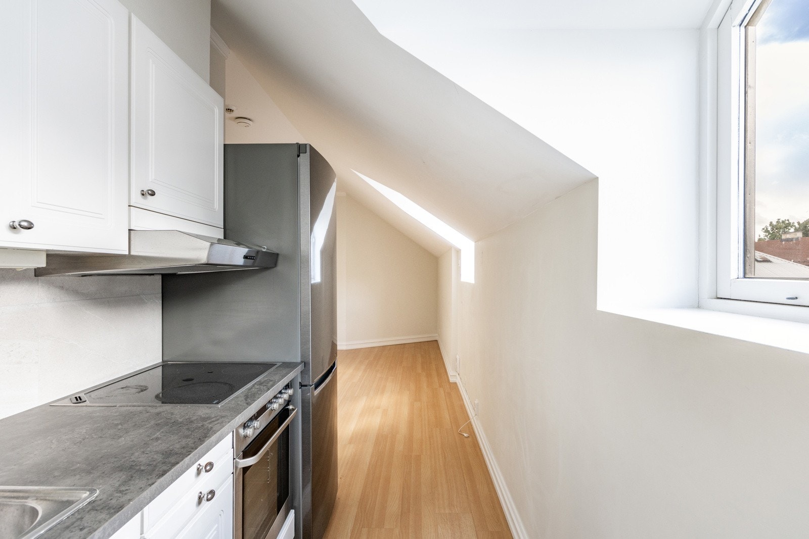 Leiligheten er utstyrt med lyst kjøkken som har innredning bestående av glatte fronter og laminat benkeplate, samt hvitevarer som kjøl/fryseskap (frittstående) og platetopp Galleribilde