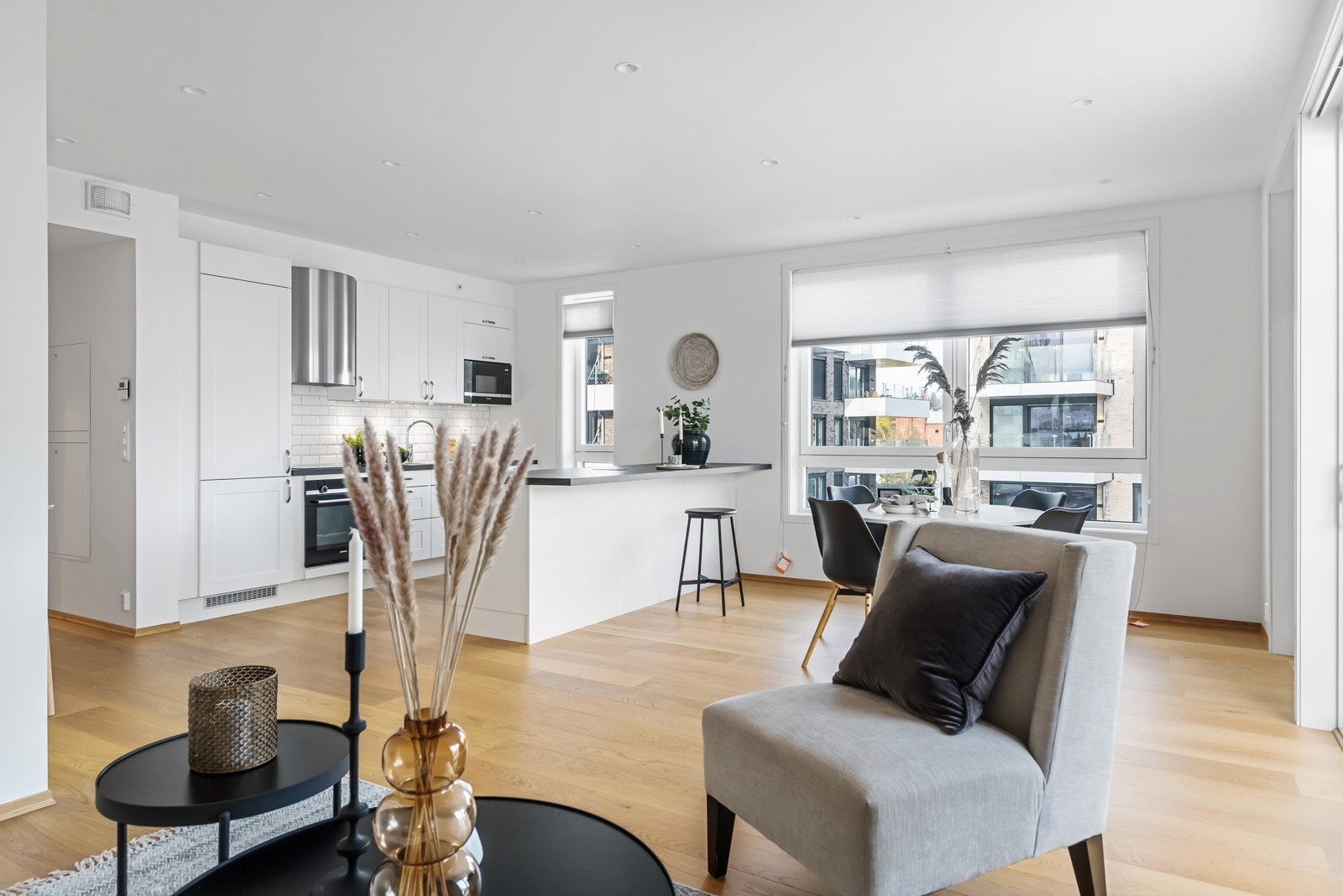 Åpen stue- og kjøkkenløsning med store vindusflater. Downlights i himling Galleribilde