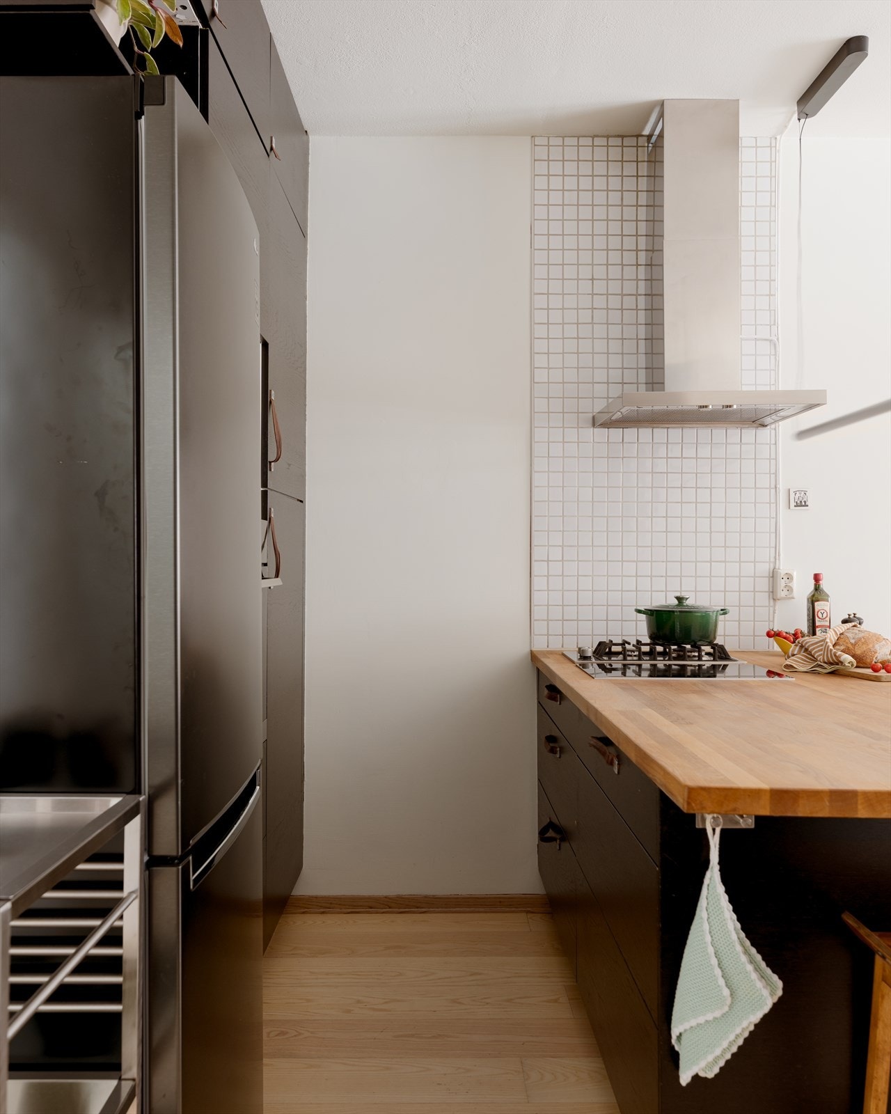 Hvitevarene består av nedfelt platetopp på kjøkkenøy, ventilator med kullfilter på vegg og integrert komfyr i høyskap. Opplegg for oppvaskmaskin under benkeplate og plass for frittstående kjøleskap. Galleribilde