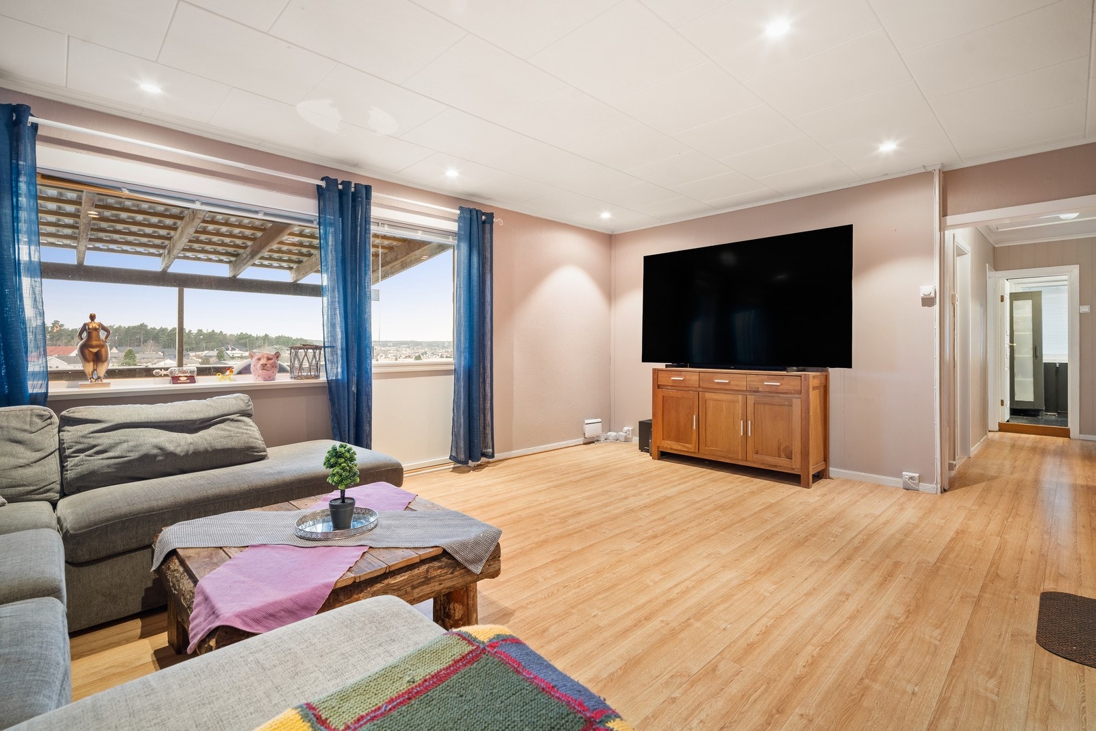 Stuen er romslig og har store vindusflater som slipper inn rikelig med naturlig lys. Galleribilde