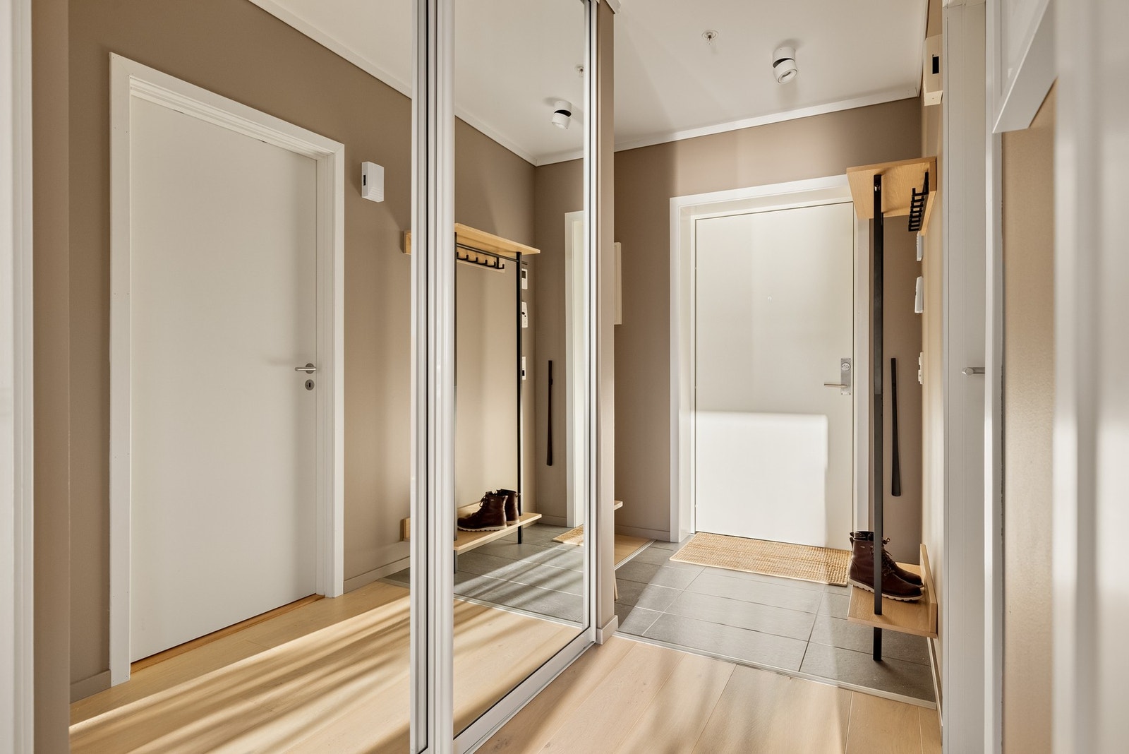 Store speilflater i skyvedørsgarderoben i entréen Galleribilde