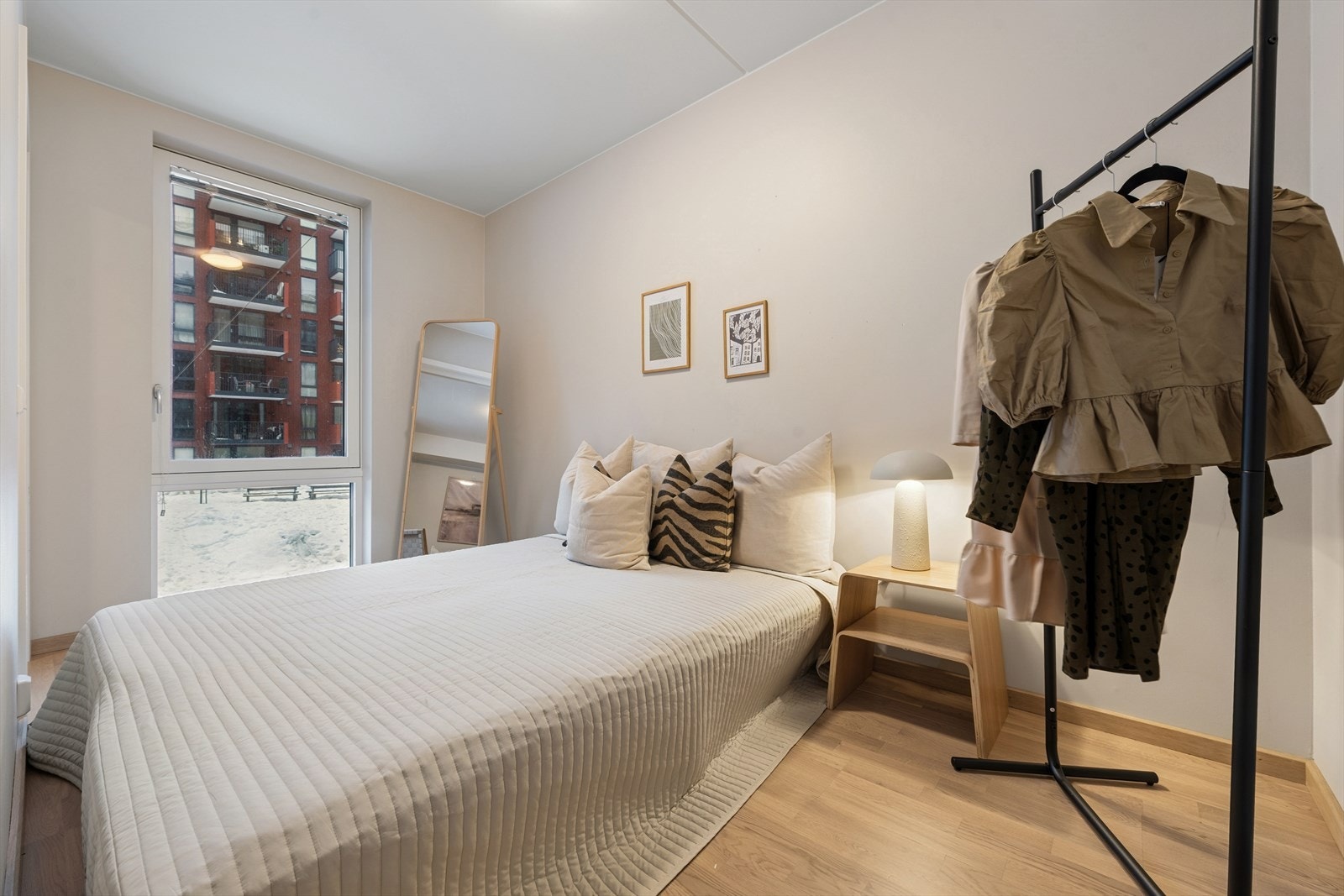 Romslig soverom med stort vindu som slipper inn rikelig med naturlig lys, og skaper en koselig atmosfære. Galleribilde