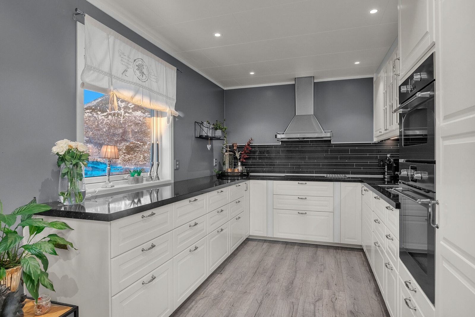 Nyere kjøkken fra ca. 2015 med en pen, tidløs innredning med profilerte fronter og laminat benkeplate. Galleribilde