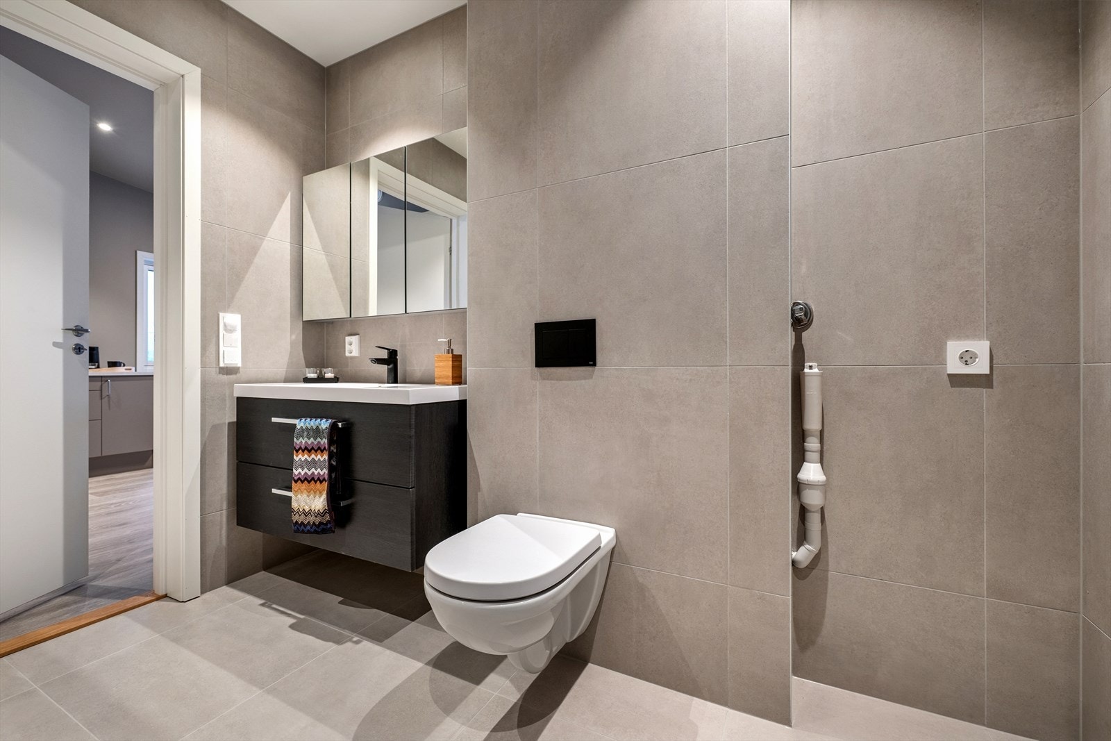 Servant nedfelt i en praktisk skapinnredning som gir gode oppbevaringsmuligheter. Vegghengt wc. Galleribilde