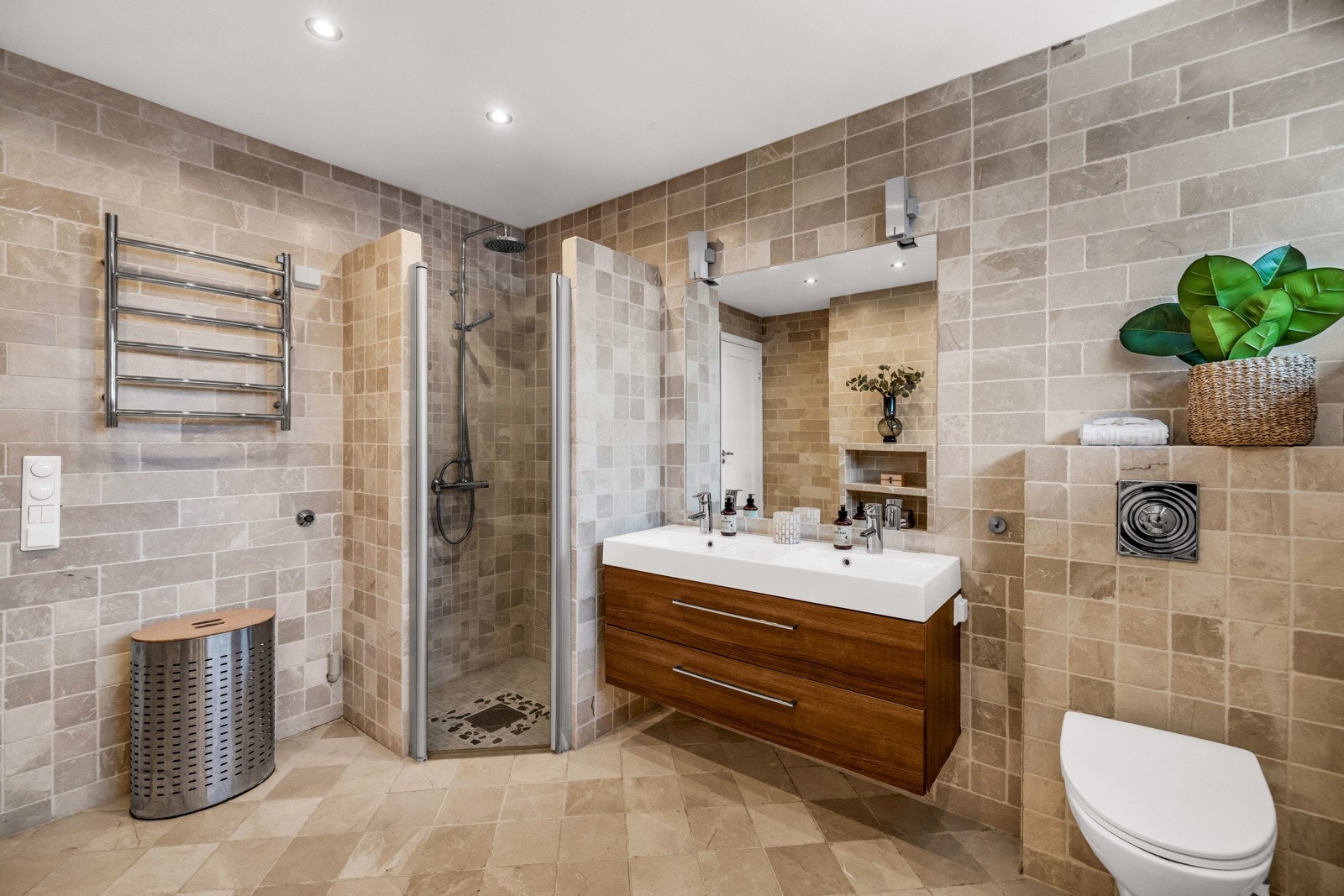 Hovedbadet i 1.etg er meget romslig med flislagte overfalter. Her finnes både dusjnisje og badekar. Galleribilde