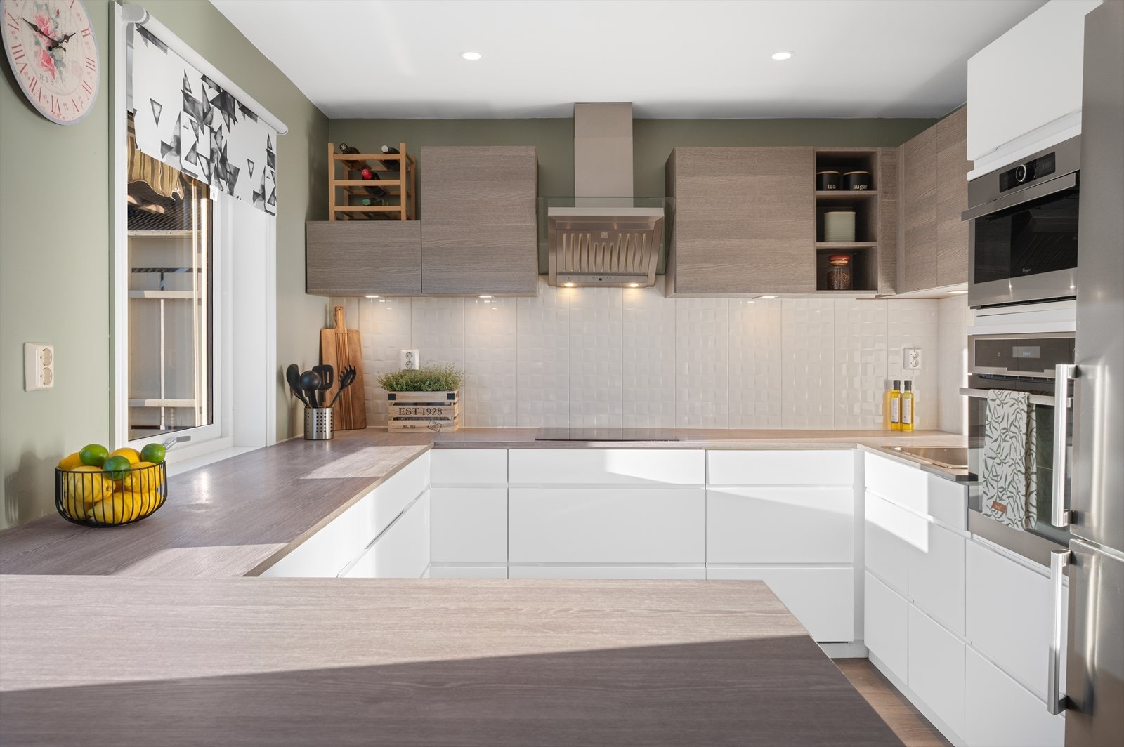 Kjøkkenet byr på en tidløs innredning med laminert benkeplate, nedfelt stålvask og glatte fronter. Galleribilde