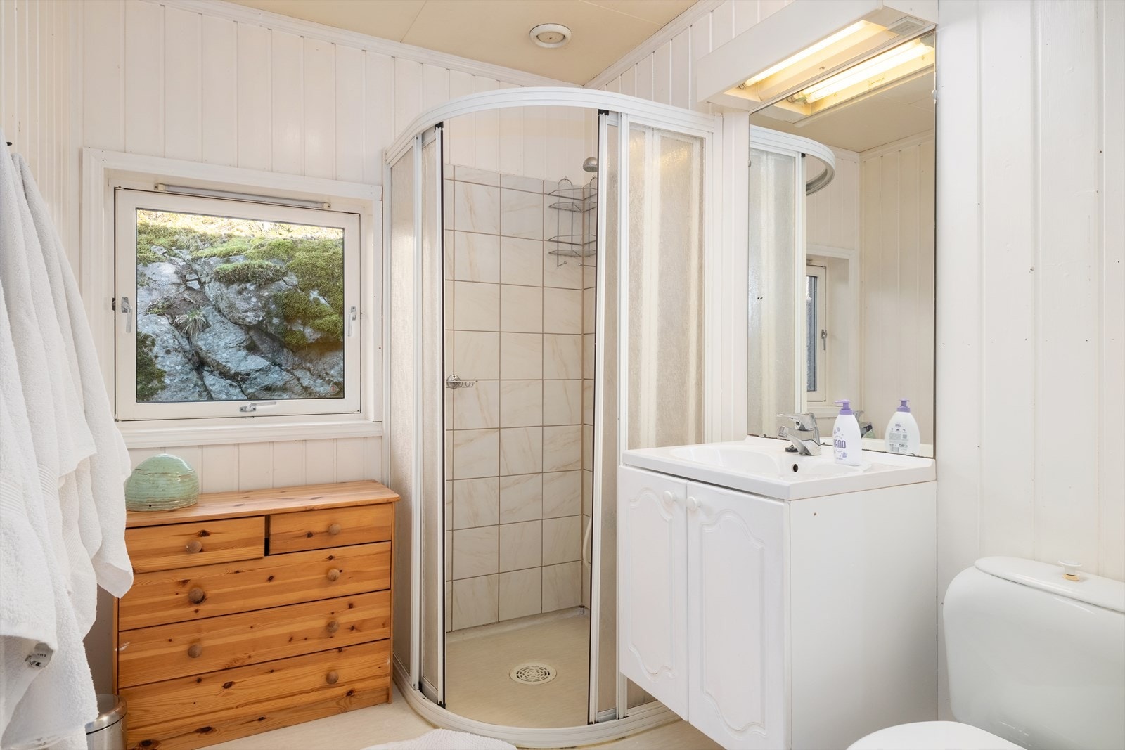 Badet har belegg på golv med varmekablar og flisar i dusjnisje. Galleribilde