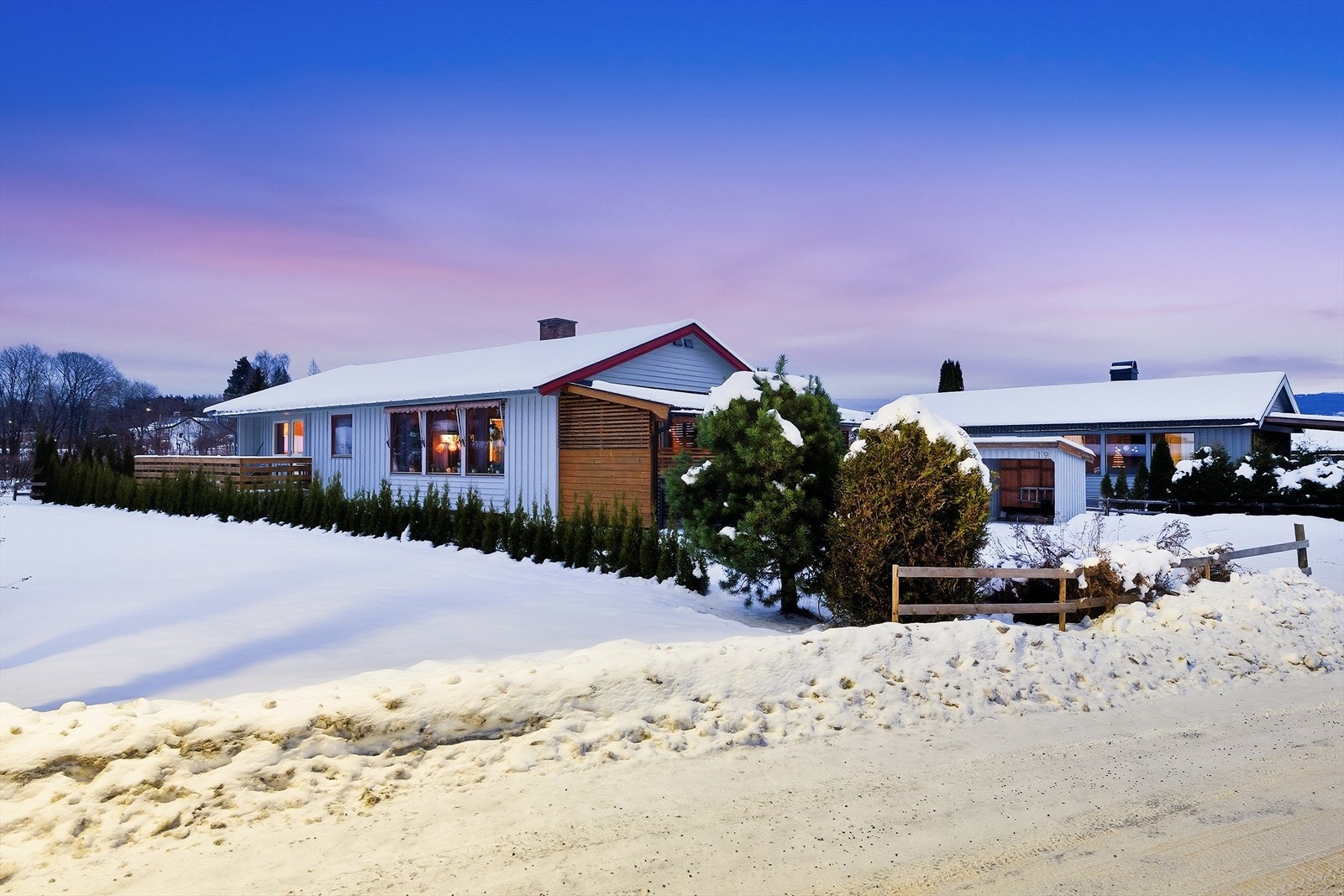 Eiendommen er delvis avskjermet med hekk. Galleribilde
