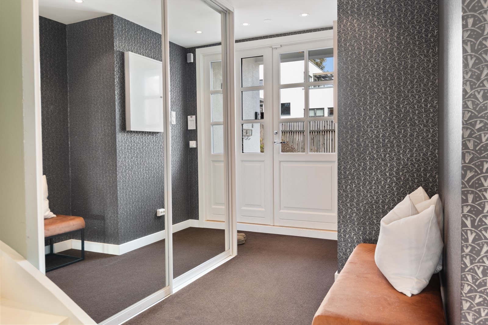 Innbydende entré med rikelig av oppbevaringsplass i plassbygde skyvdører. Galleribilde