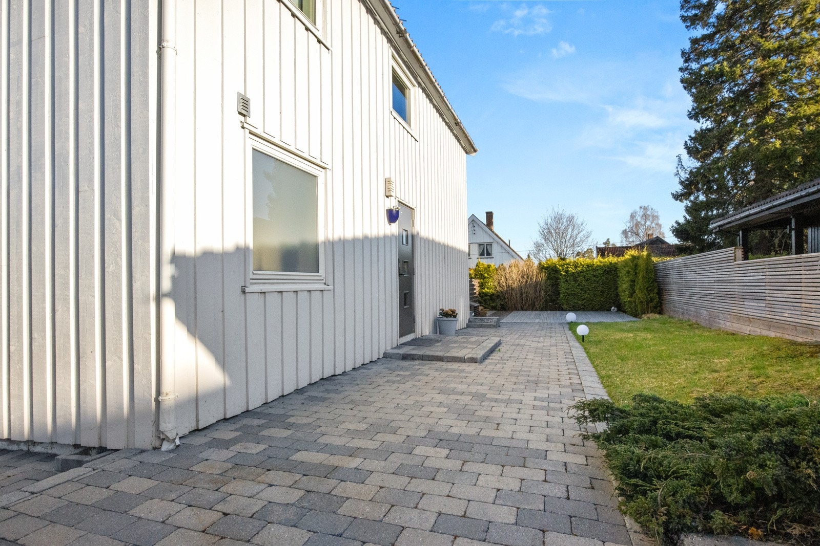 Pent, steinbelagt inngangsparti. Galleribilde