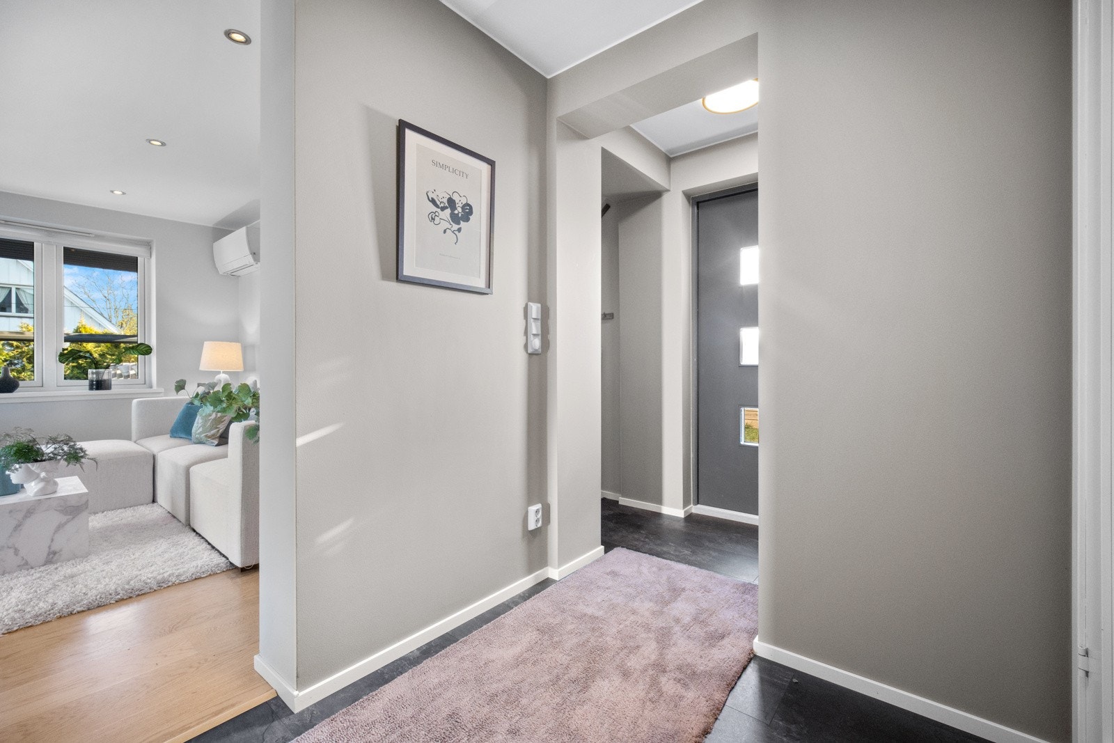 Man blir ønsket velkommen inn i entréen som gir ett godt førsteinntrykk. Her er veggene malt i en dus gråtone, og det er lagt koksgrå laminatfliser på gulvet. Galleribilde