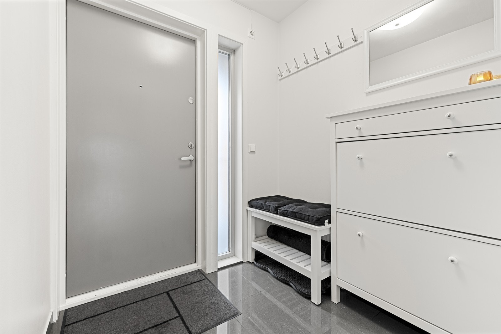 Innbydende entré med flislagt gulv og en solid ytterdør fra Bor Døren. Velkommen inn! Galleribilde