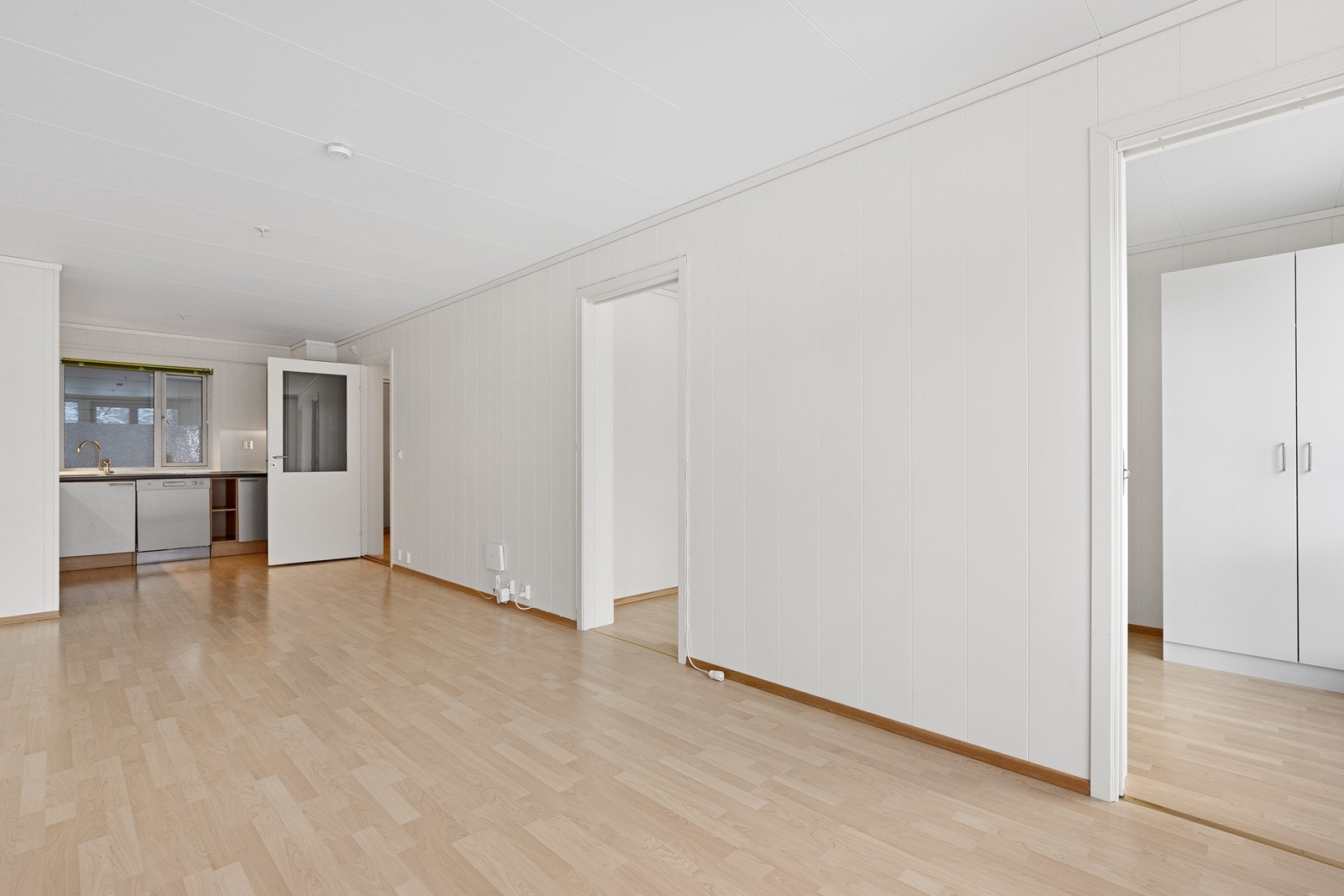 Gjennomgående laminatgulv og lyse veggflater. To dører inn til soverom. Galleribilde