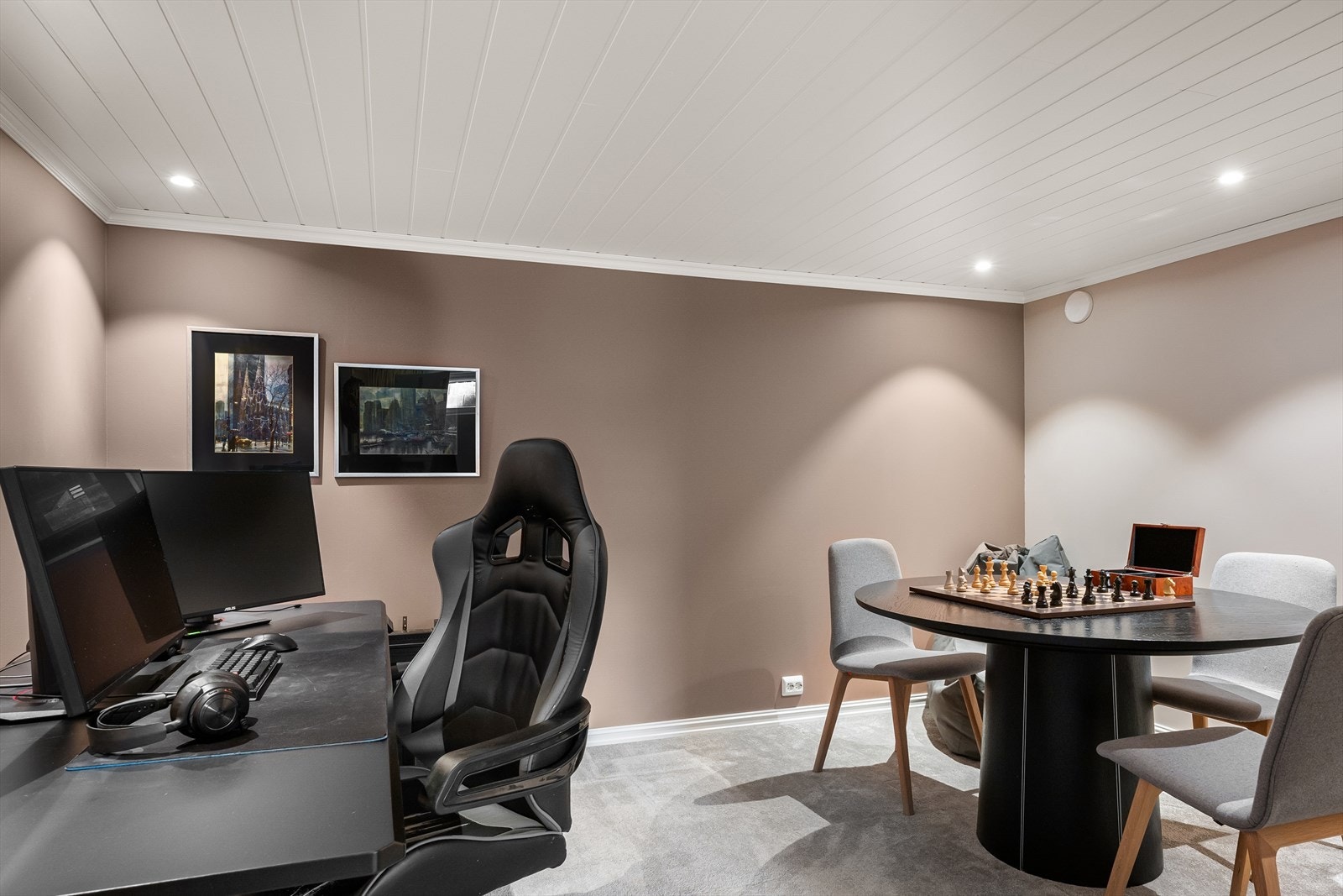 Stor kjellerstue med lunt, moderne teppe og peis/grue for ekstra kos. Avdelt med bokhylle for egen sone til gaming og poker/spill. Galleribilde