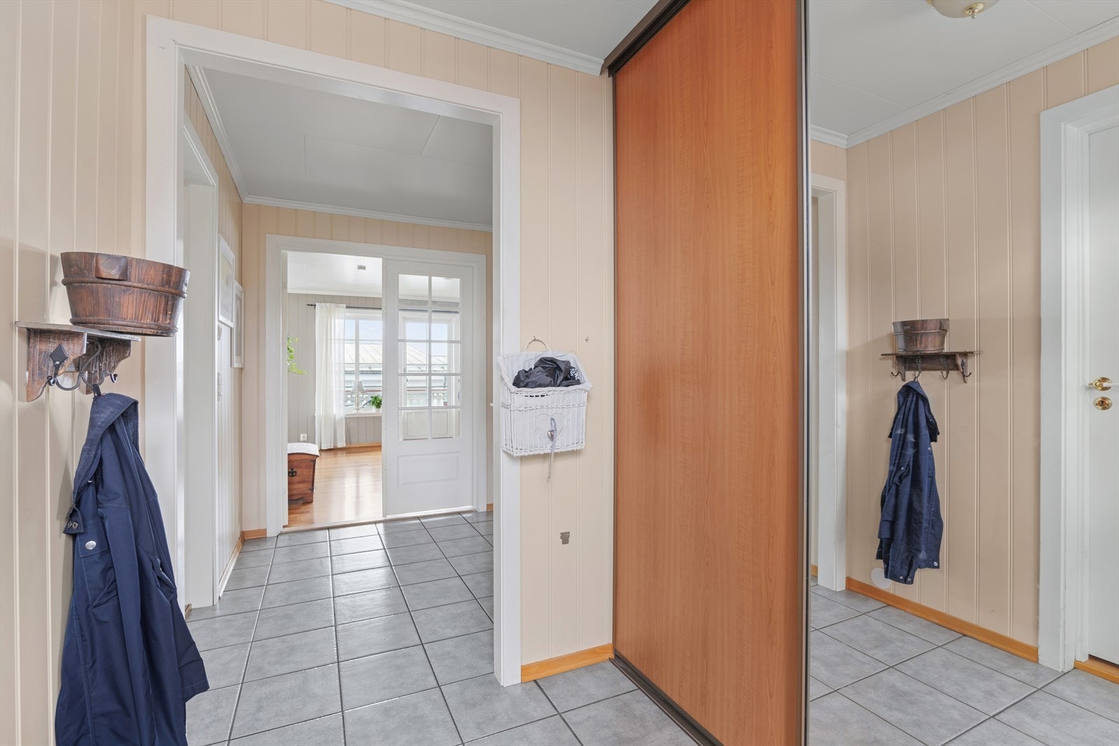 Velkommen inn! Entréen gir et godt førsteinntrykk med god plass til sko og yttertøy. Skyvedørsgarderobeskapene fra gulv til tak gjør det enkelt å holde orden. Galleribilde