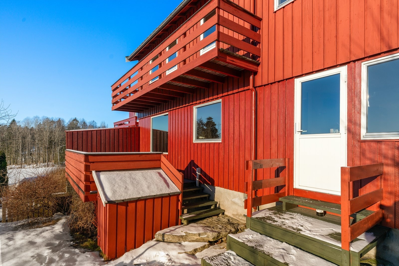 Boligen har flere uteplasser, inkludert en terrasse og en balkong i andre etasje. Galleribilde