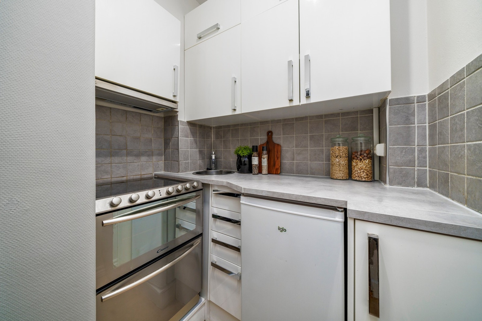 Kjøkken med innredning med glatte fronter og laminat benkeplate. Kjøkkenet er utstyrt med kjøleskap og komfyr. Avtrekk via byggets sentrale avtrekksanlegg. Galleribilde