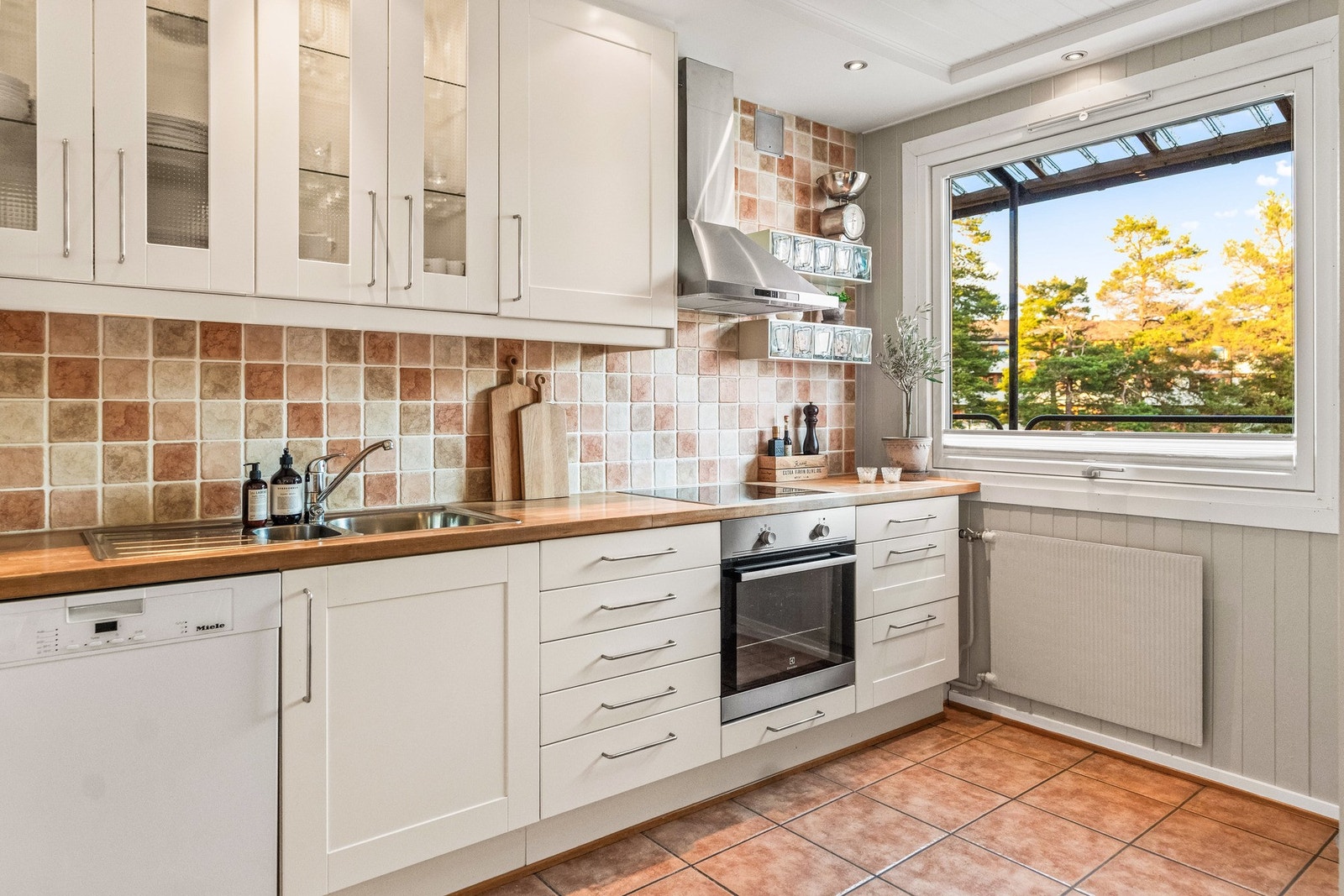 Det er nedfelt dobbel oppvaskkum i rustfritt stål med ett-greps armatur og praktisk oppvaskløsning. Galleribilde