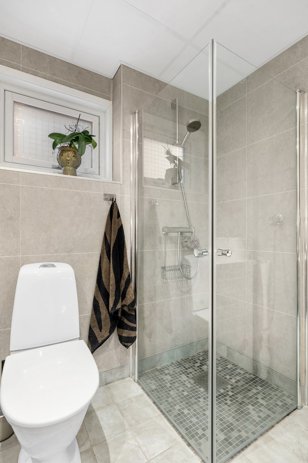 Dusjnisje med innfellbare glassdører som sikrer en praktisk og plassbesparende løsning. Galleribilde