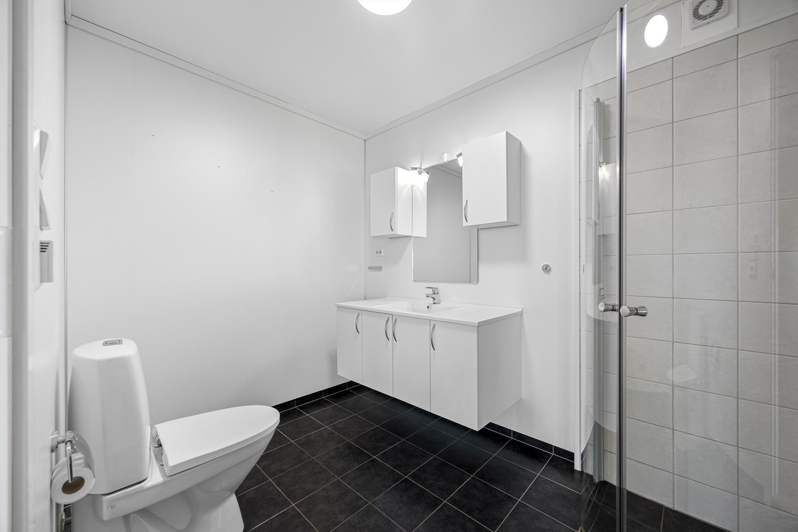 Badet har innredning med nedfelt servant og toalett, samt dusjvegger. Galleribilde