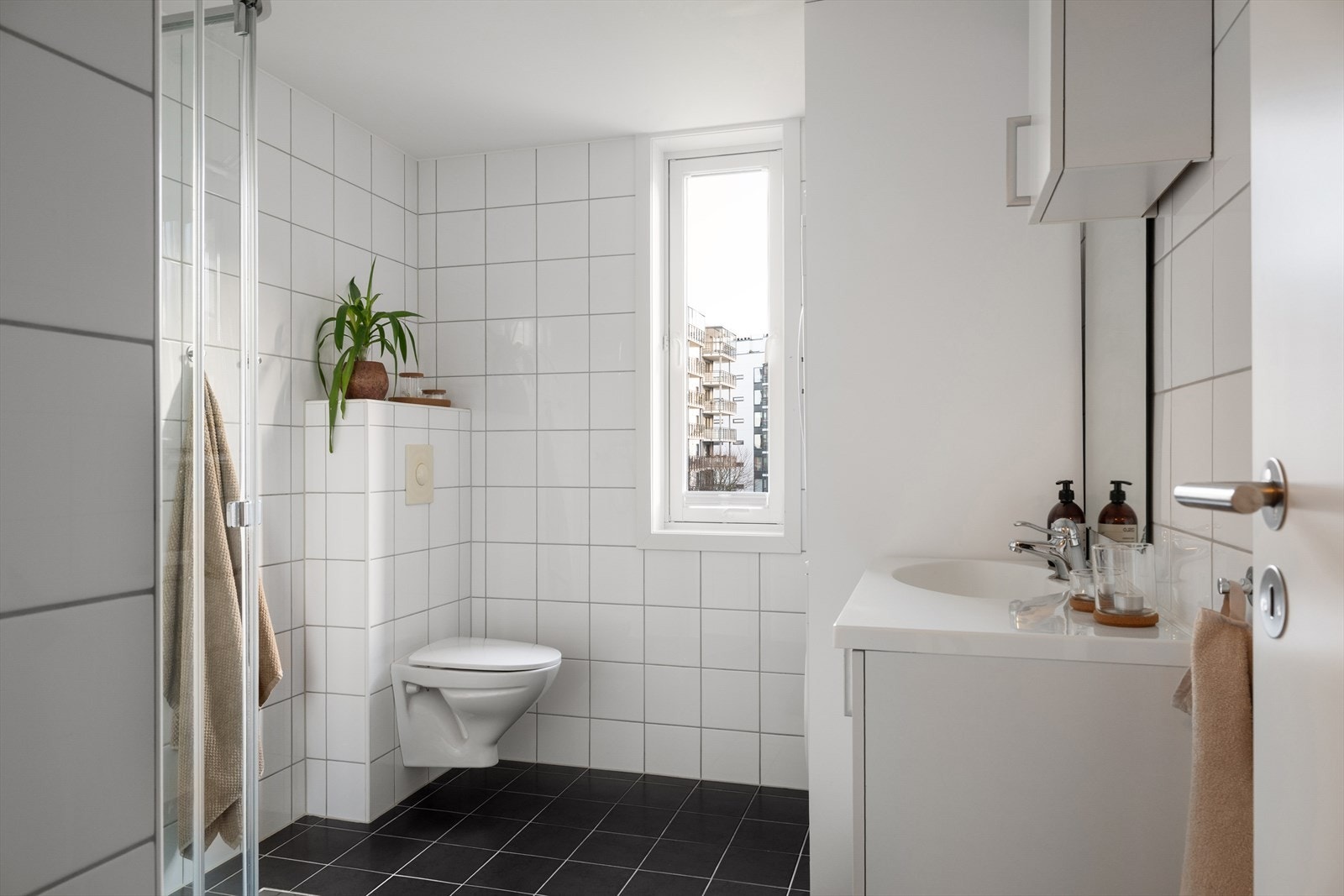 Tidløst helfliset baderom med downlights i himling og vannbåren varme i gulv. Galleribilde