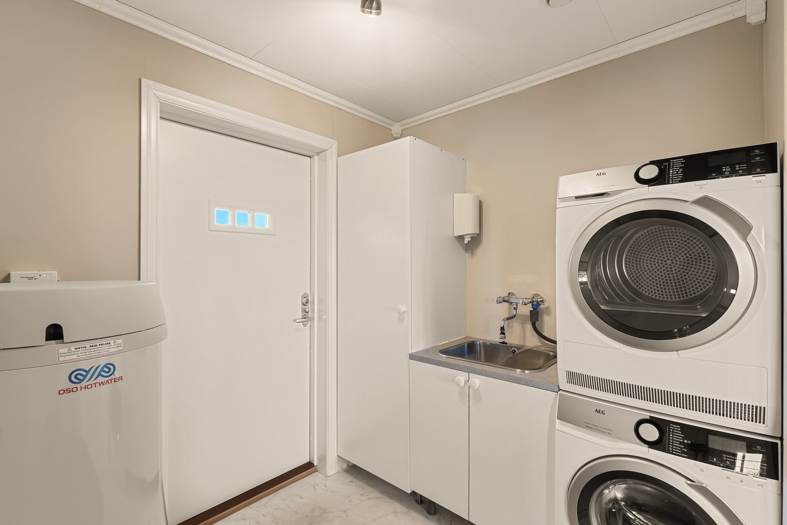 Praktisk vaskerom med egen inngang utenfra - en stor fordel i en aktiv familiehverdag. Galleribilde