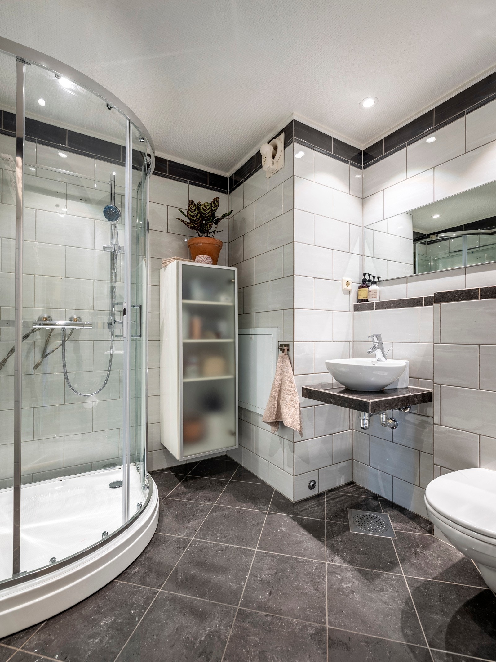 Badet i andre etasje fremstår pent med flislagte vegger og gulv, varmekabler og innfelt downlights. Galleribilde