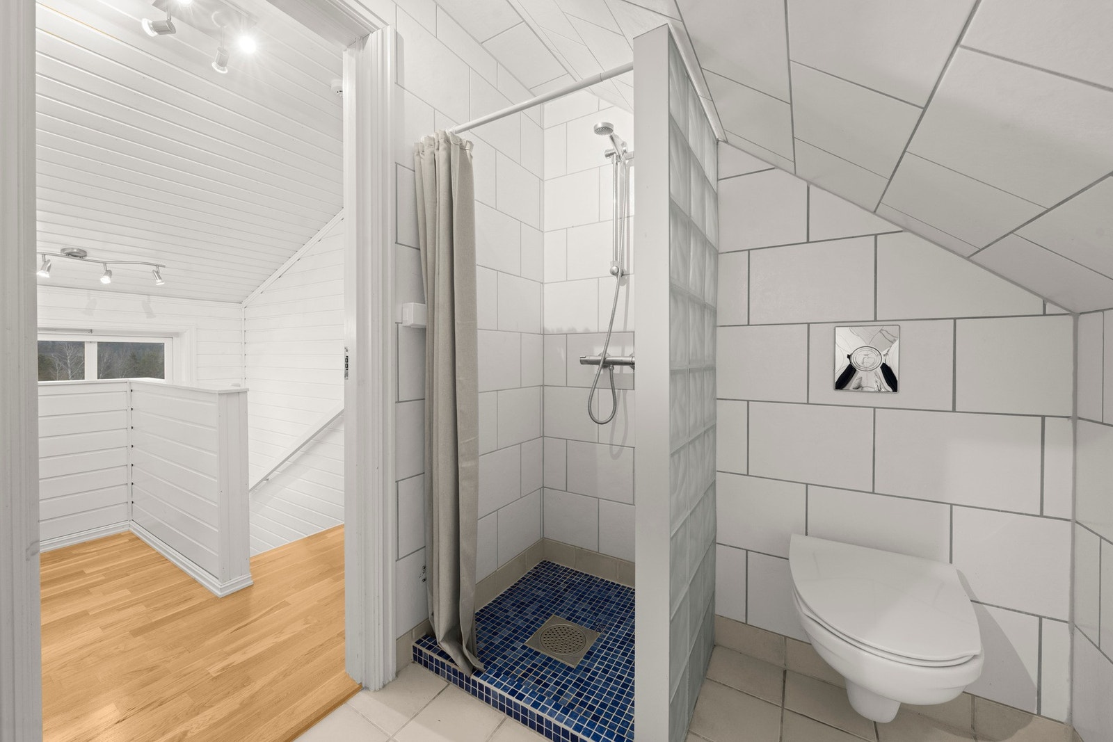 Rommet er utstyrt med vegghengt toalett, servant og dusjnisje. Galleribilde