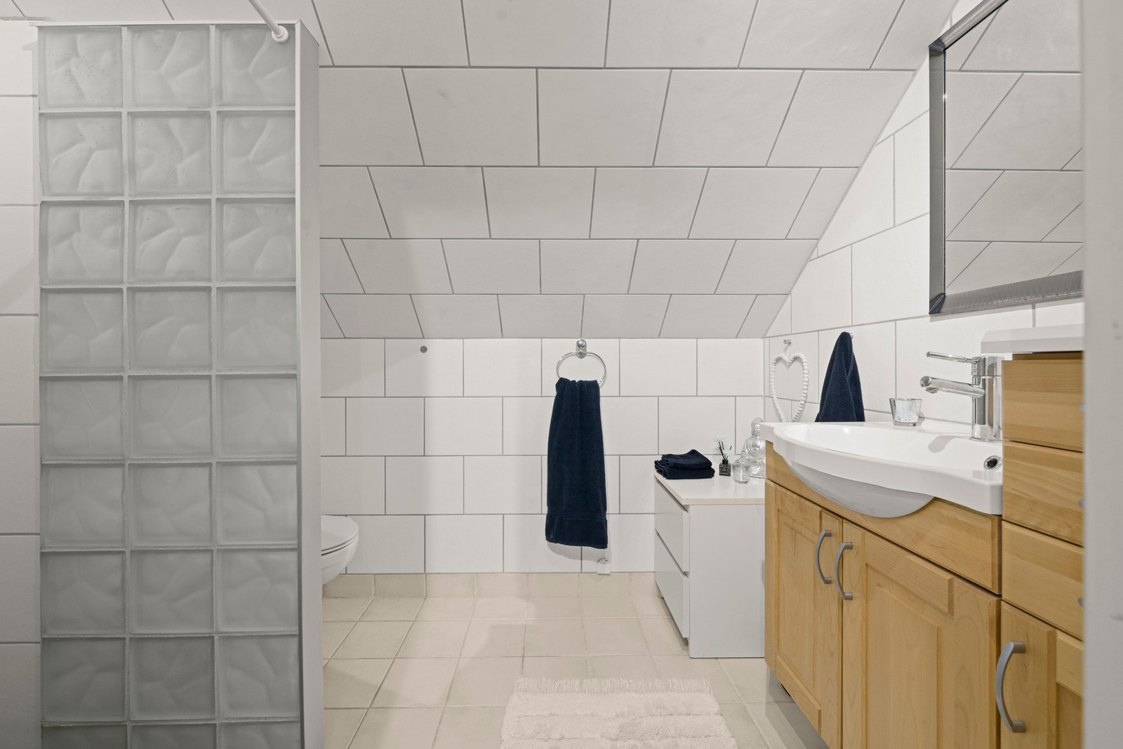 Badet har fliser på gulv, vegger og himling samt gulvvarme. Galleribilde