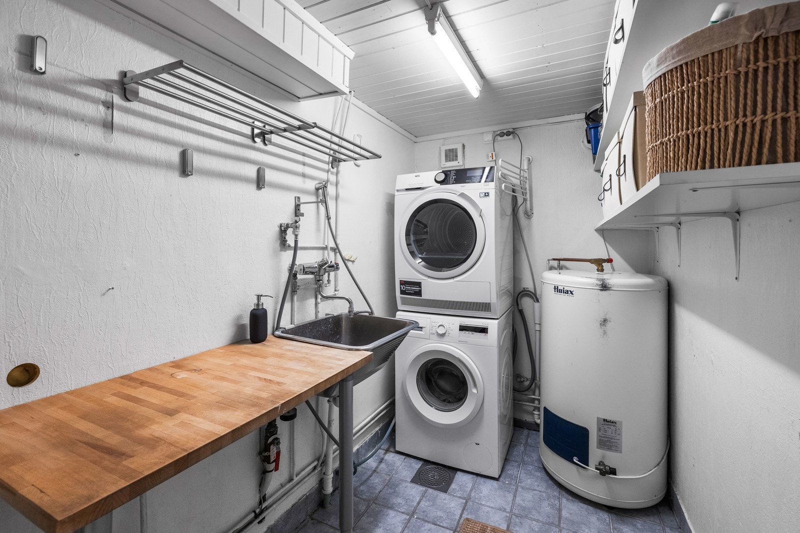 Vaskerom med plass til vaskesøyle, arbeidsbenk og oppbevaring. Galleribilde