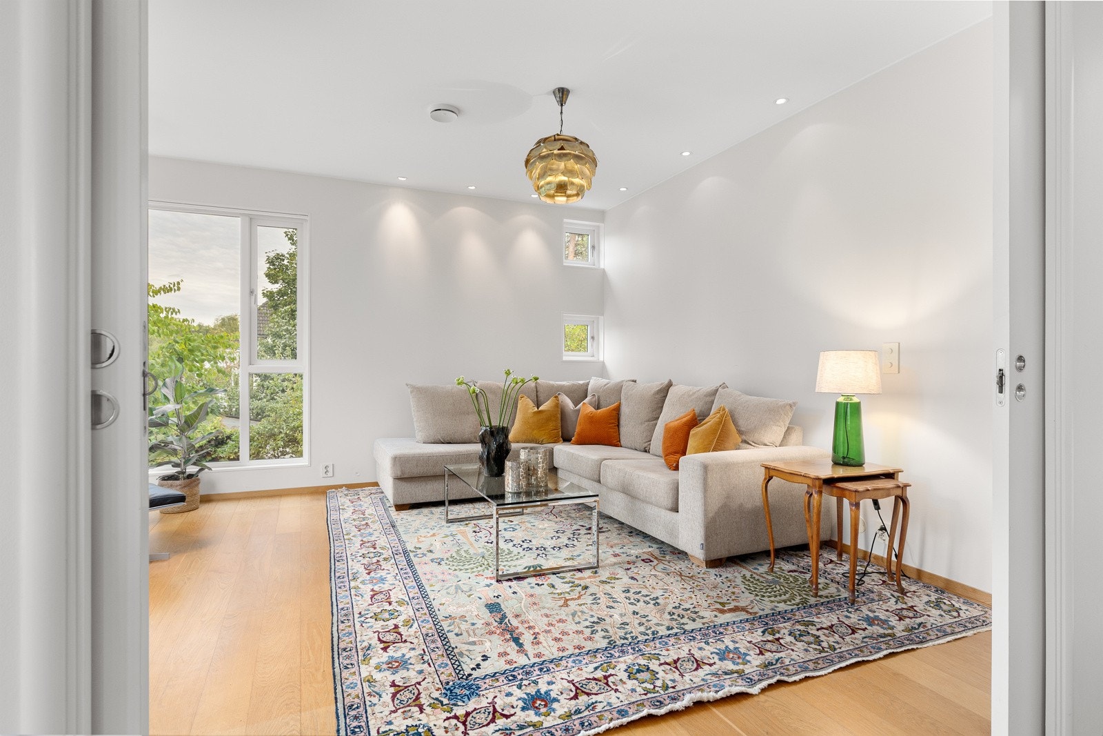 Peisestuen utmerker seg med store vindusflater som gir godt med naturlig lys, og byr på plass til sofahjørne og øvrig innredning Galleribilde