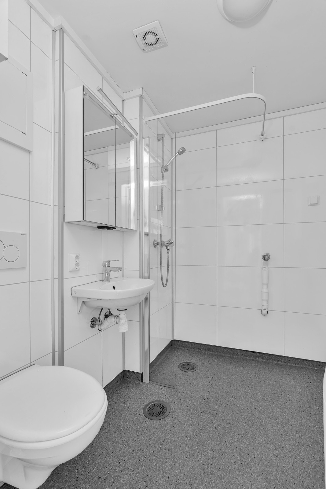 Det er porselensvask, vegghengt wc, dusjhjørne samt opplegg til vaskemaskin i rommet Galleribilde