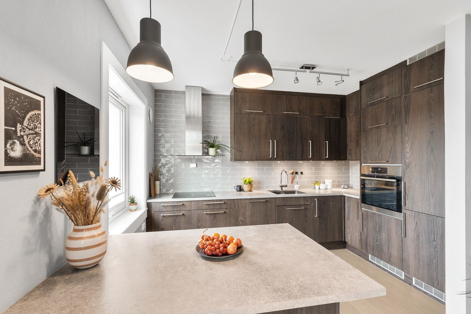 Stilrent kjøkken med moderne innredning og rikelig med skap og benkeplass. Galleribilde