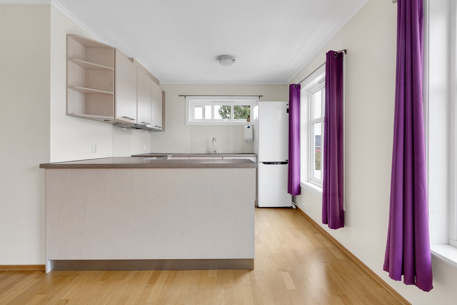 Kjøkkenet er lyst og pent og har godt med benkeplass. Galleribilde