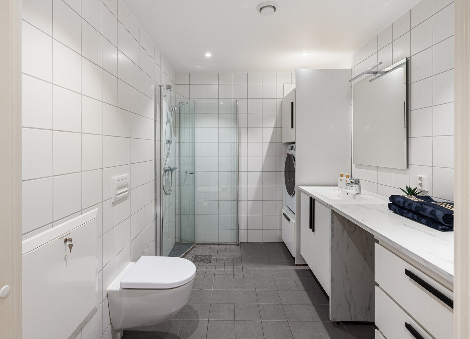 Romslig baderom med moderne utførelse og tidløse materialvalg. Det er etablert gulvvarme som sørger for behagelig komfort året rundt. Galleribilde